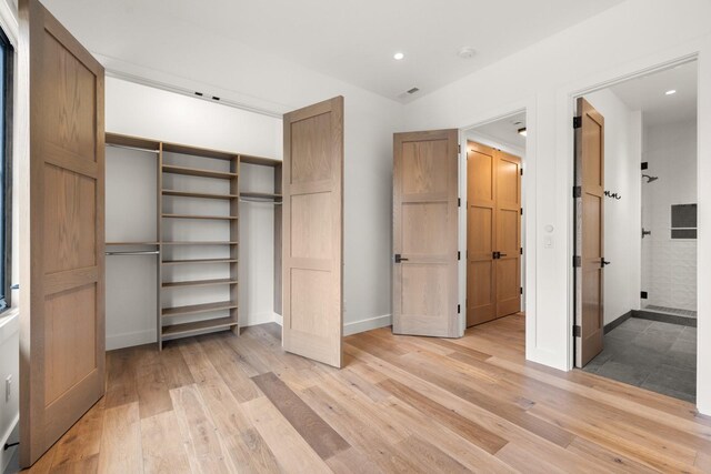 unfurnished bedroom with recessed lighting, baseboards, a closet, and light wood-type flooring
