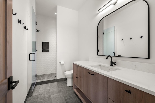 full bath featuring vanity, toilet, baseboards, and a stall shower