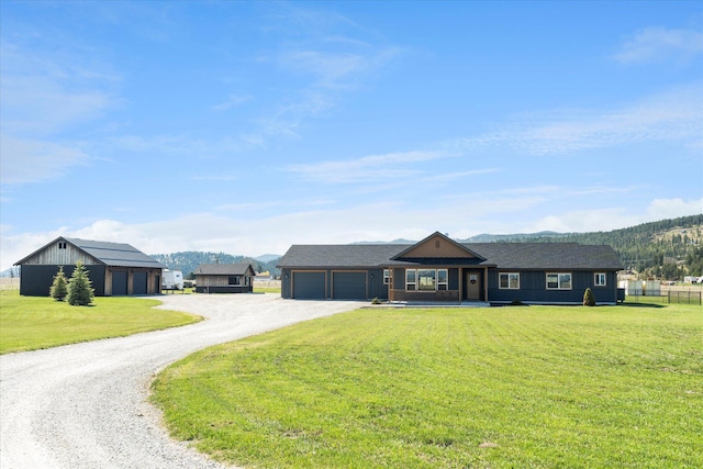 view of front of property featuring an attached garage, dirt driveway, a front lawn, and covered porch