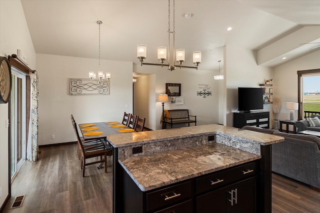 kitchen featuring visible vents, dark wood-style flooring, a chandelier, and vaulted ceiling