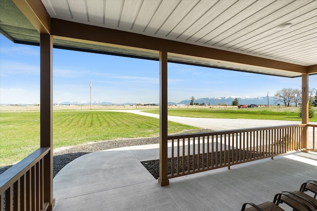 view of patio / terrace with a mountain view and a rural view