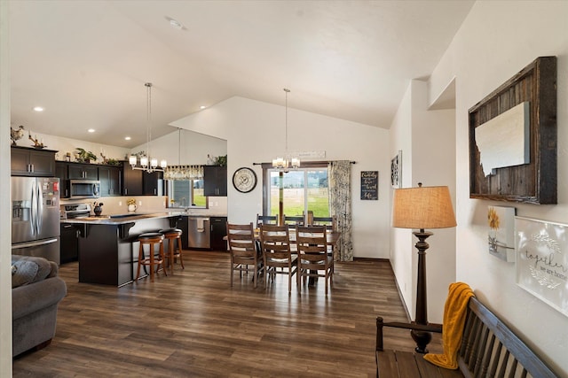 dining area with recessed lighting, a chandelier, dark wood finished floors, and vaulted ceiling