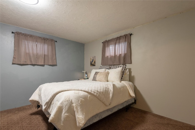 carpeted bedroom featuring a textured ceiling