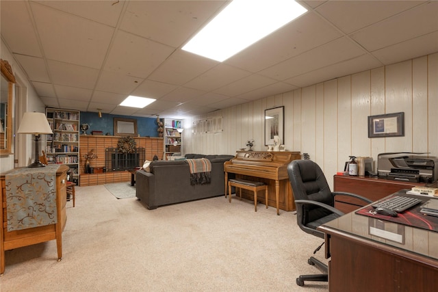 carpeted office space with a paneled ceiling