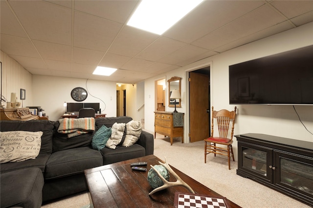 living room featuring carpet flooring and a paneled ceiling