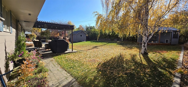 view of green lawn with an outbuilding
