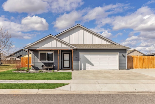 1521 Cheery Dr, Belgrade, MT 59714 - view of front of house with board and batten siding, an attached garage, fence, and concrete driveway