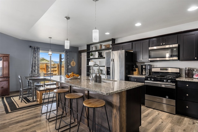 1521 Cheery Dr, Belgrade, MT 59714 - kitchen with a sink, light wood finished floors, light stone countertops, and stainless steel appliances