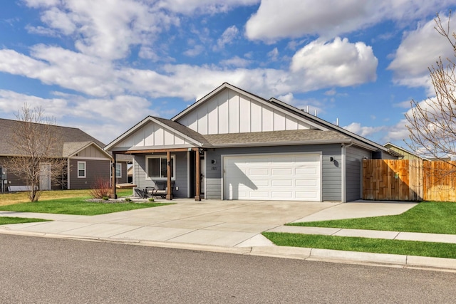 1521 Cheery Dr, Belgrade, MT 59714 - view of front of property featuring fence, roof with shingles, an attached garage, board and batten siding, and concrete driveway