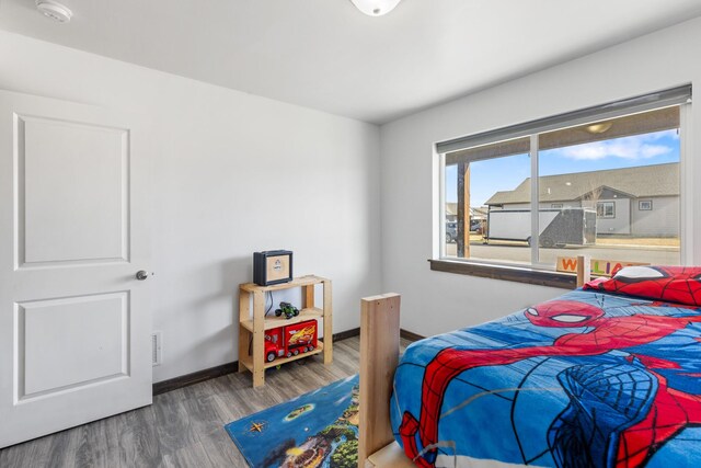 1521 Cheery Dr, Belgrade, MT 59714 - bedroom with baseboards, wood finished floors, and visible vents