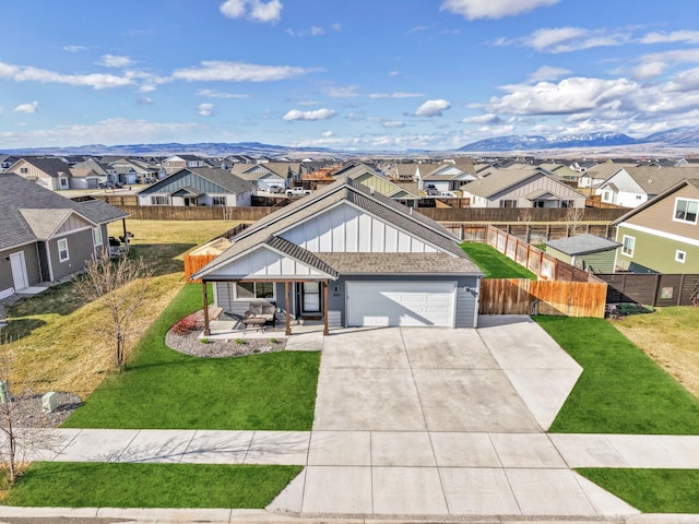 1521 Cheery Dr, Belgrade, MT 59714 - view of front of property featuring board and batten siding, fence, driveway, and a residential view