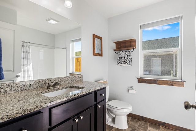 1521 Cheery Dr, Belgrade, MT 59714 - bathroom with baseboards, curtained shower, a healthy amount of sunlight, and toilet