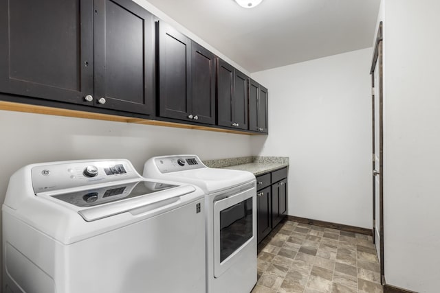1521 Cheery Dr, Belgrade, MT 59714 - washroom with baseboards, stone finish flooring, cabinet space, and washer and clothes dryer