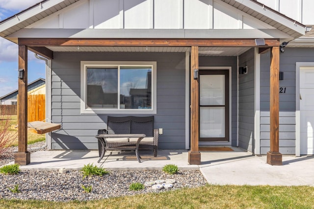 1521 Cheery Dr, Belgrade, MT 59714 - view of exterior entry featuring fence, covered porch, and board and batten siding