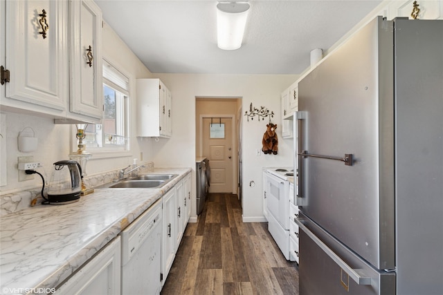 kitchen with white appliances, white cabinetry, a sink, and dark wood-type flooring