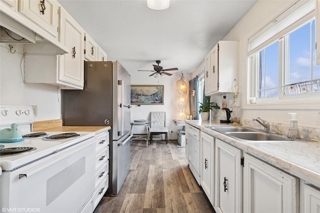kitchen with white appliances, ceiling fan, under cabinet range hood, a sink, and dark wood finished floors