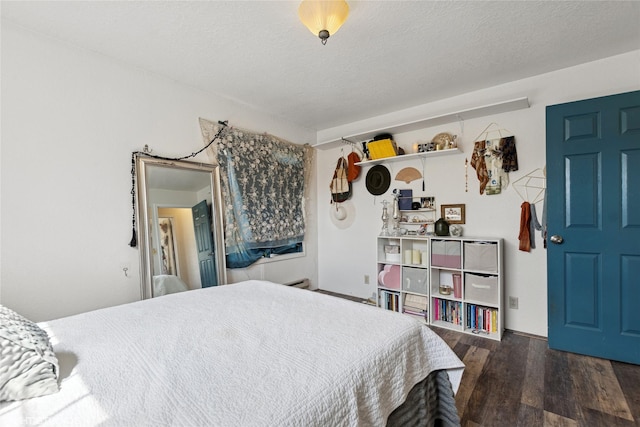 bedroom featuring a textured ceiling and wood finished floors