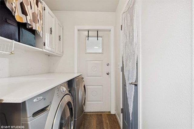 laundry room with cabinet space, dark wood-style flooring, and washing machine and dryer