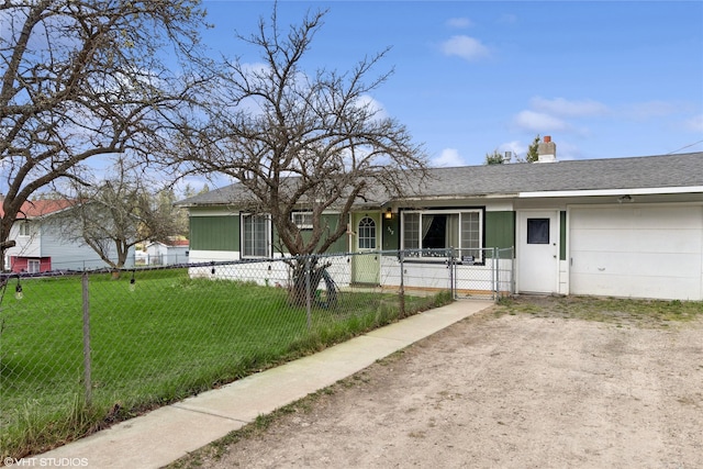 ranch-style home with a front lawn, a chimney, an attached garage, a fenced front yard, and driveway