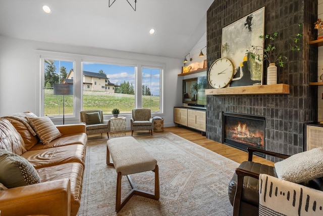 1007 Pheasant Ridge Dr, Kalispell, MT 59901 - living area featuring vaulted ceiling, a fireplace, wood finished floors, and recessed lighting