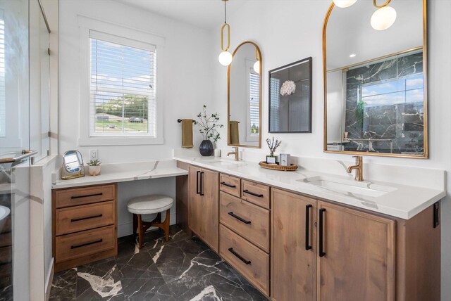 full bath featuring double vanity, a sink, and marble finish floor