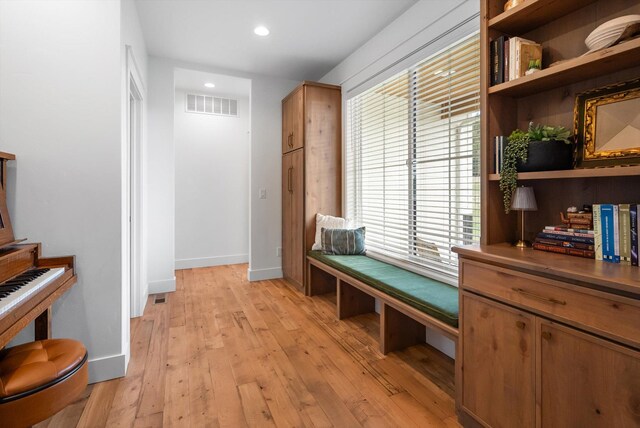 hallway featuring recessed lighting, baseboards, visible vents, and light wood-style flooring