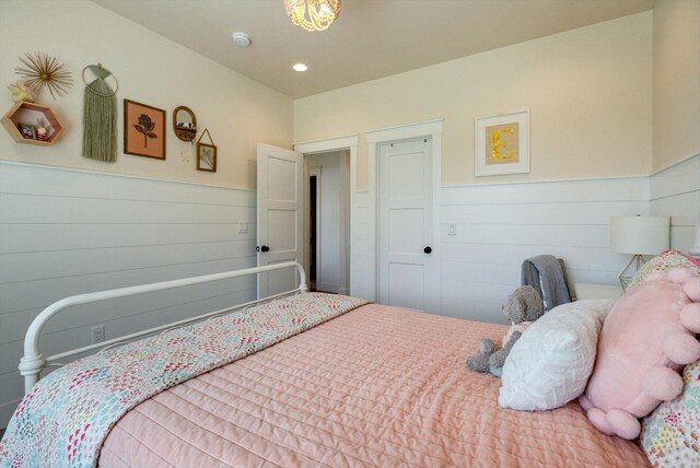 bedroom with recessed lighting and wainscoting