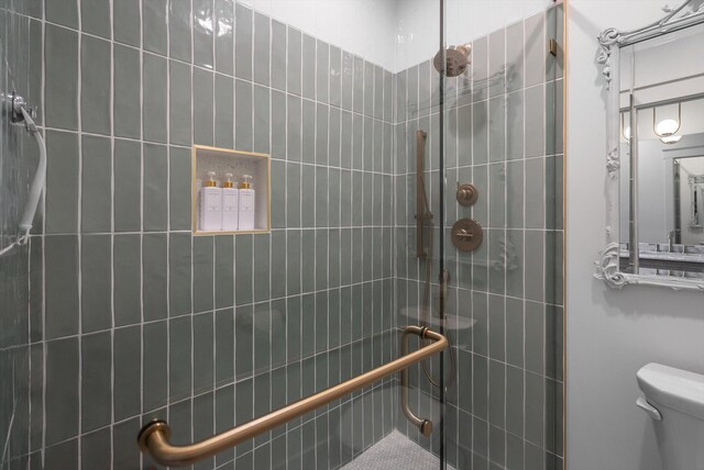 full bathroom featuring a stall shower and toilet