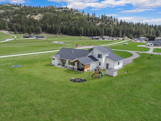 birds eye view of property with a view of trees