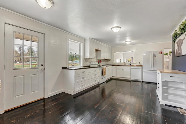 kitchen with dark wood-style flooring, open shelves, a sink, white appliances, and white cabinetry
