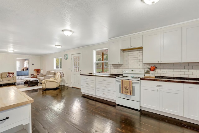 kitchen featuring white range with electric cooktop, backsplash, dark wood-style floors, and open floor plan