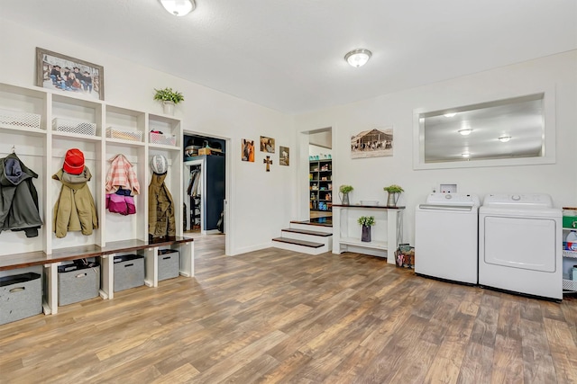 mudroom with wood finished floors, baseboards, and washing machine and dryer