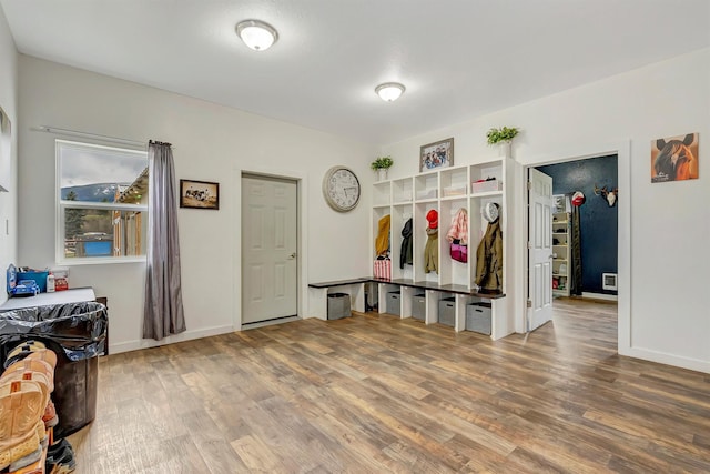 mudroom featuring baseboards, visible vents, and wood finished floors