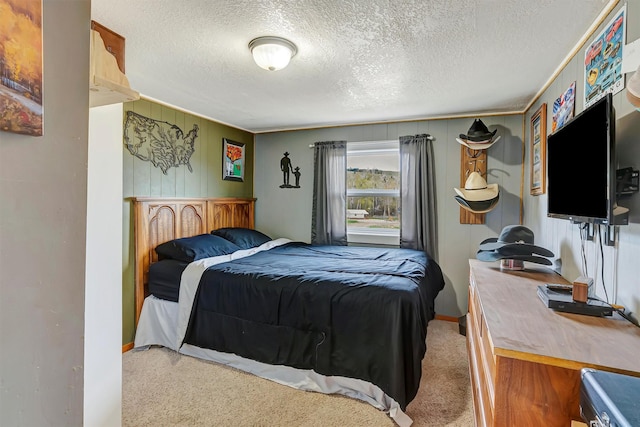 bedroom with carpet floors, a textured ceiling, and baseboards