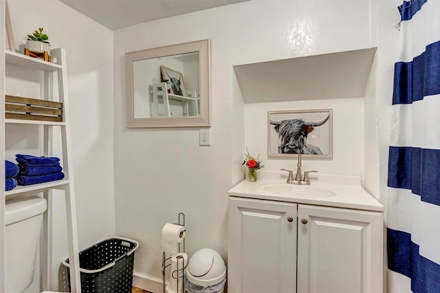 bathroom with toilet and vanity