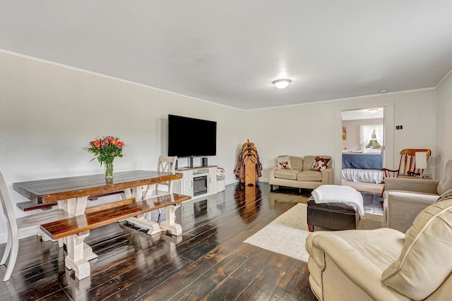 living room featuring crown molding and dark wood-style flooring