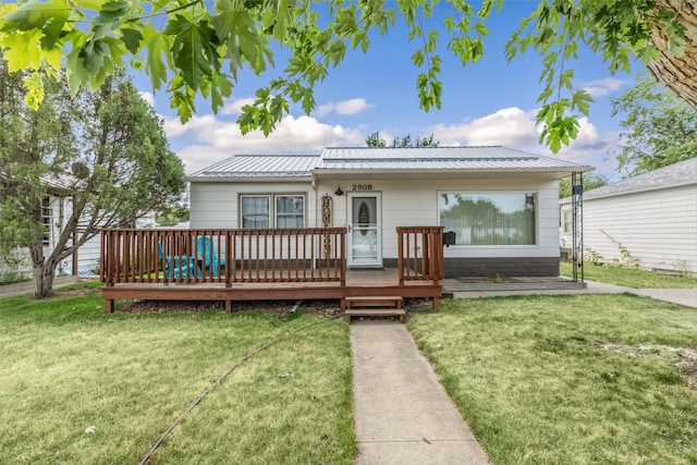 2908 6th Ave S, Great Falls, MT 59405 - view of front of house with a wooden deck, metal roof, and a front lawn