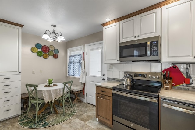 2908 6th Ave S, Great Falls, MT 59405 - kitchen featuring light countertops, stainless steel appliances, white cabinetry, and decorative backsplash