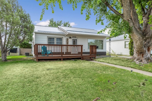 2908 6th Ave S, Great Falls, MT 59405 - rear view of house with a lawn, a wooden deck, and metal roof