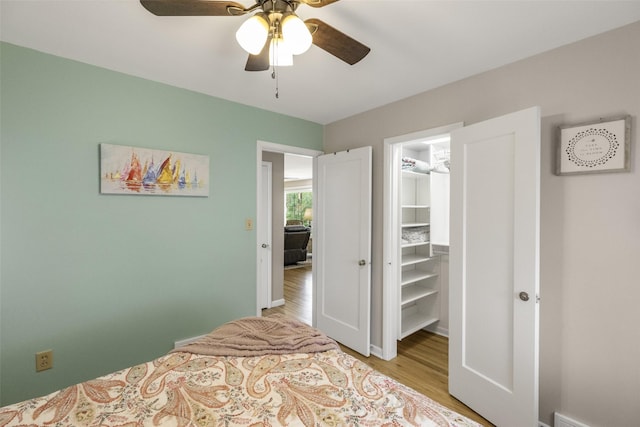 2908 6th Ave S, Great Falls, MT 59405 - bedroom featuring a closet, a walk in closet, a ceiling fan, and light wood-type flooring