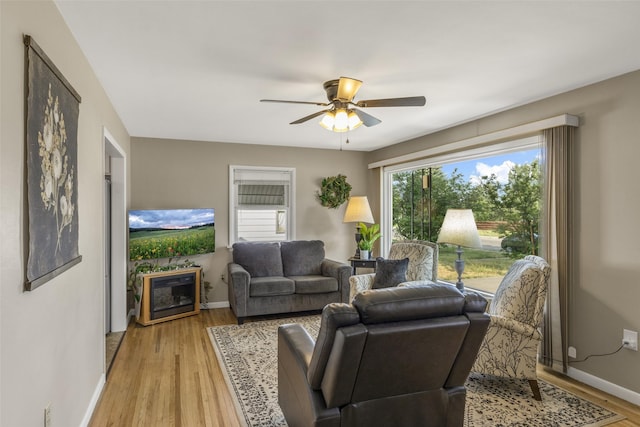 2908 6th Ave S, Great Falls, MT 59405 - living area featuring a fireplace, a ceiling fan, baseboards, and light wood-type flooring