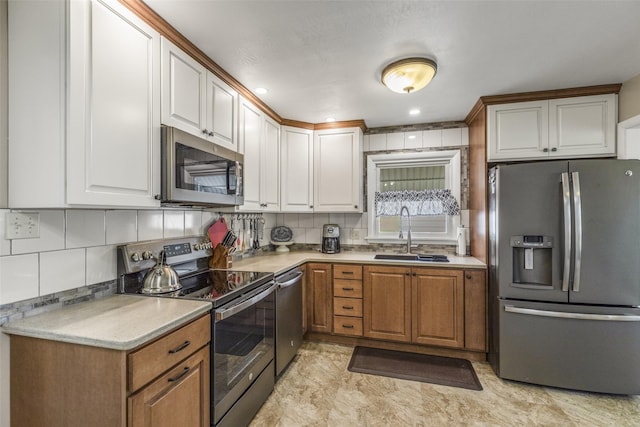 2908 6th Ave S, Great Falls, MT 59405 - kitchen with decorative backsplash, a sink, light countertops, stainless steel appliances, and white cabinetry
