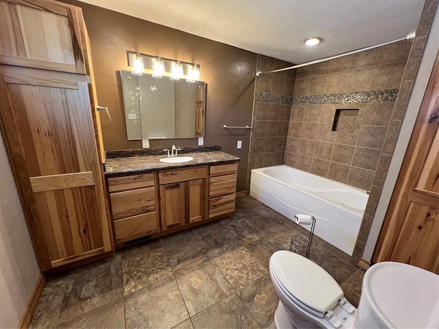bathroom with vanity, baseboards, shower / bathtub combination, and toilet