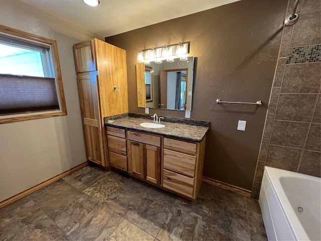 full bath featuring baseboards and vanity