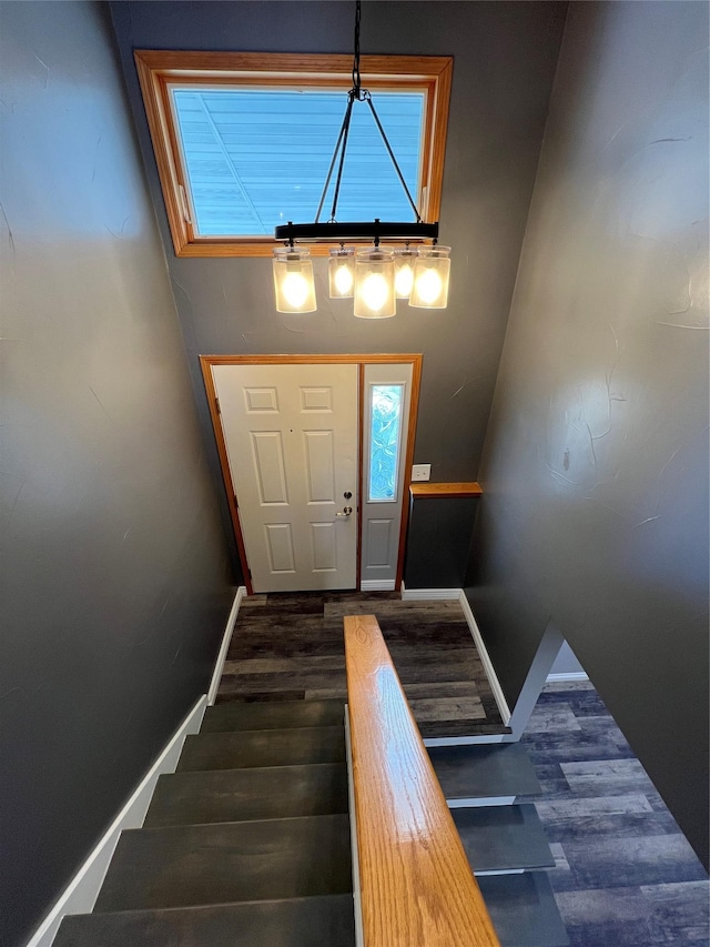 staircase with baseboards and wood finished floors