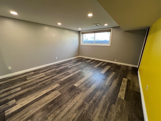 unfurnished room featuring recessed lighting, baseboards, visible vents, and dark wood finished floors