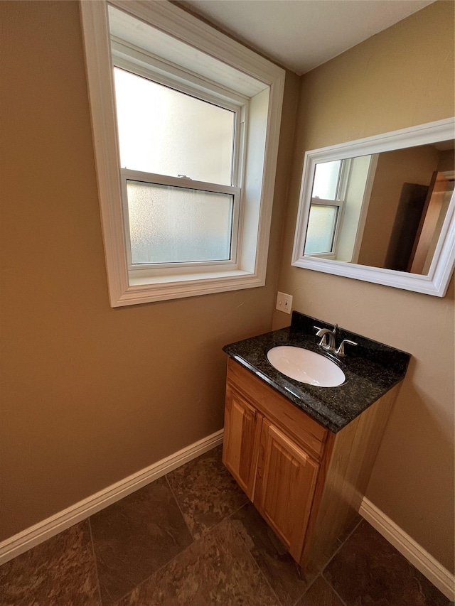 bathroom featuring vanity and baseboards