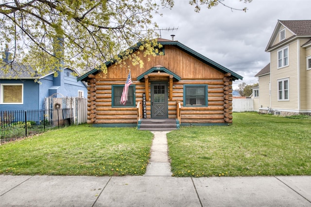 308 S 4th St, Hamilton, MT 59840 - log cabin with a front lawn, fence, and log siding