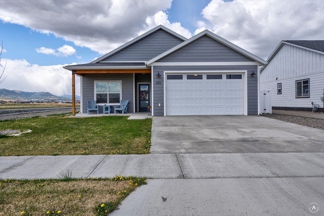 2800 Ashley Ave, East Helena, MT 59635 - view of front of house with a garage, a front lawn, a porch, a mountain view, and driveway
