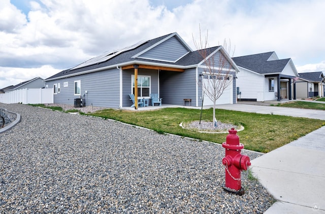 2800 Ashley Ave, East Helena, MT 59635 - ranch-style house with a garage, fence, roof mounted solar panels, and a front yard